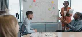 Consultants planning together at a whiteboard