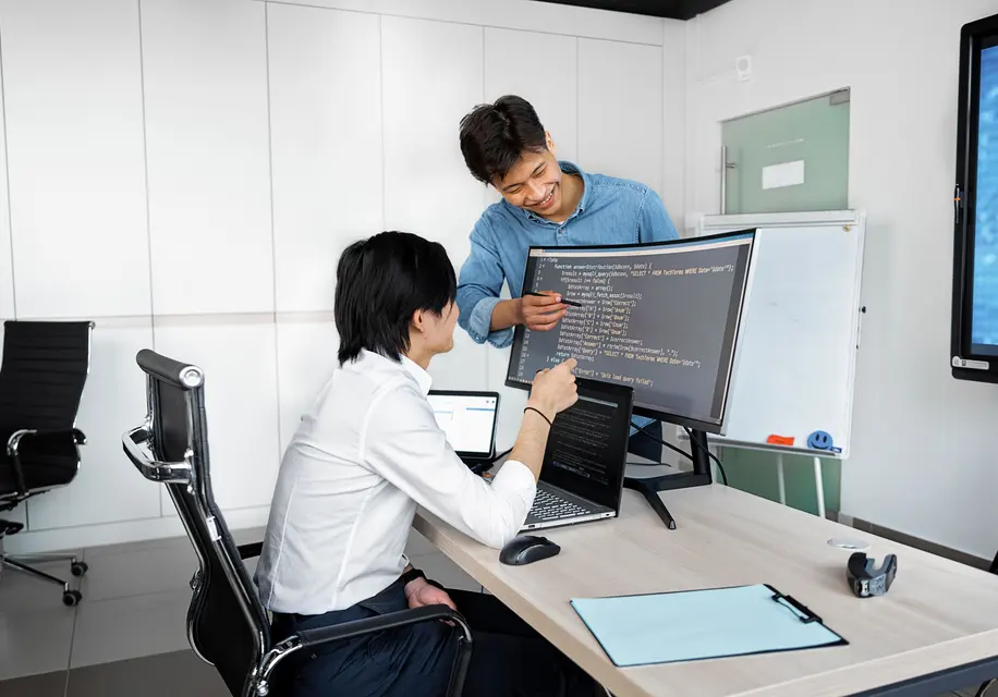 Engineers validating software against requirements